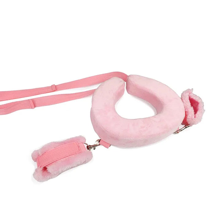 Soft pink intimate restraint set for couples featuring adjustable straps and plush cuffs