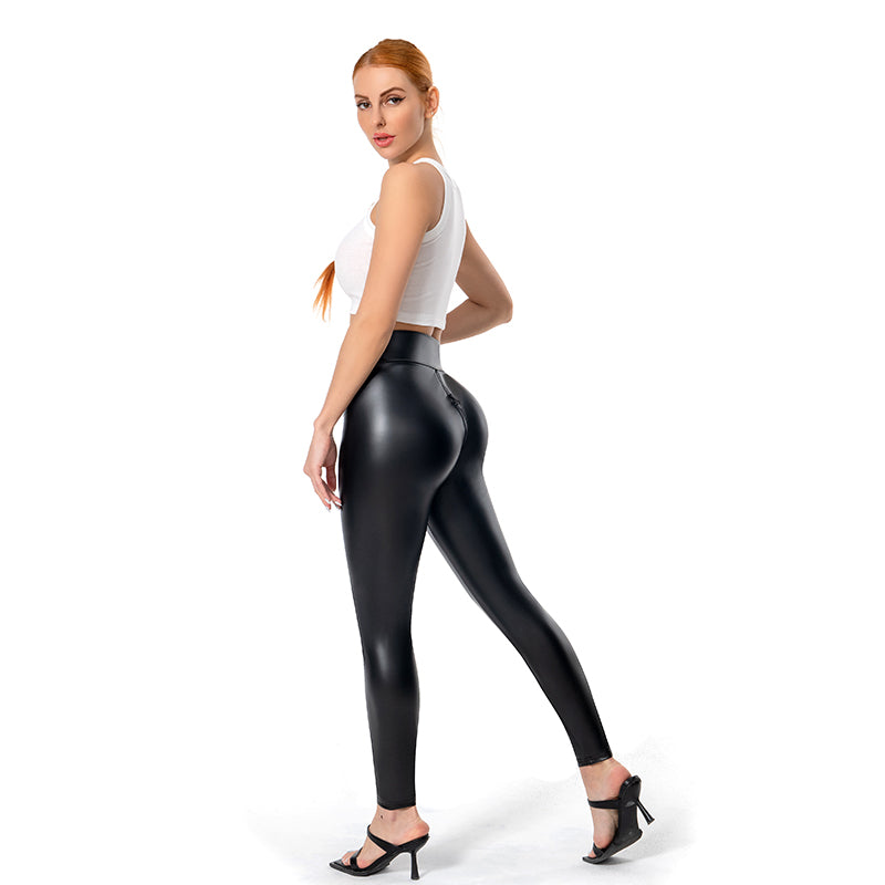 Woman modeling matte leather trousers for women in black with a white crop top and black heels