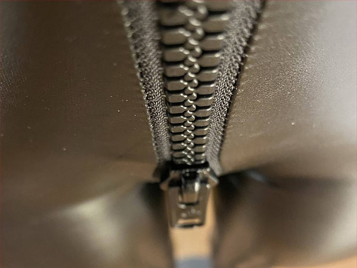 Close-up detail of zipper on matte leather trousers for women by GhallasGoth