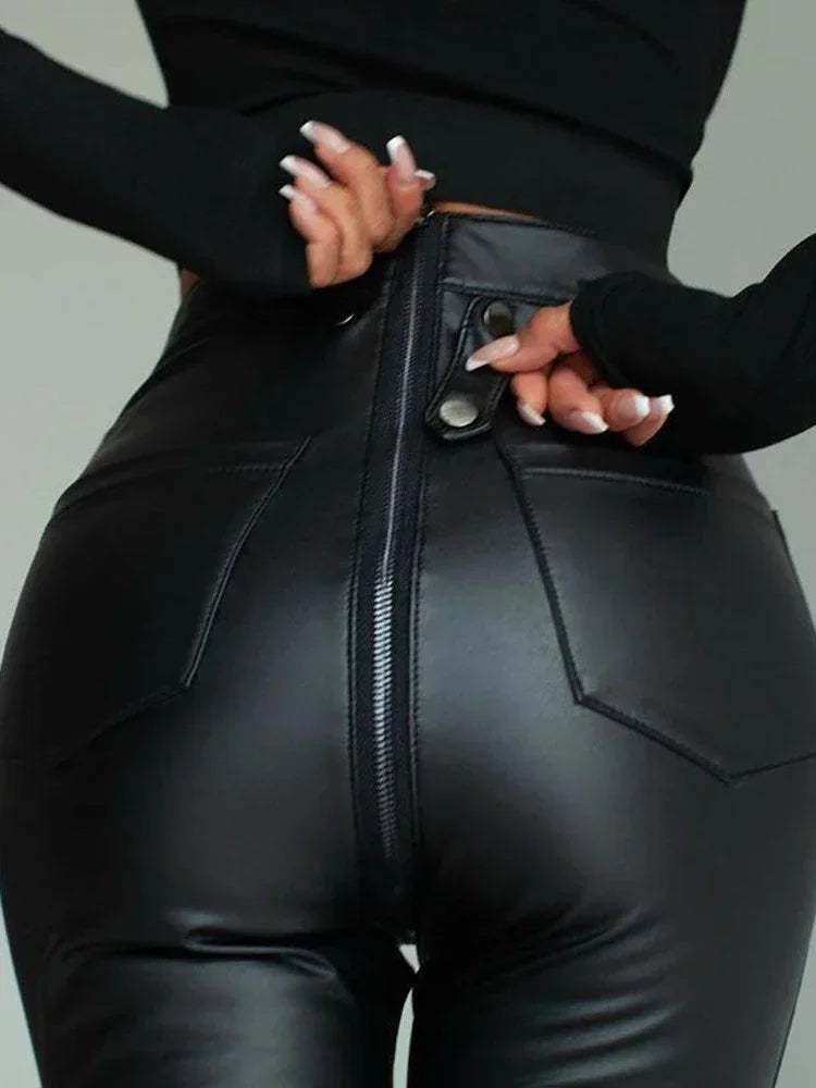 Close-up of black leather zipper trousers showing the back zipper and pocket details