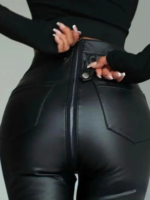 Close-up of black leather zipper trousers with back pockets and a button detail