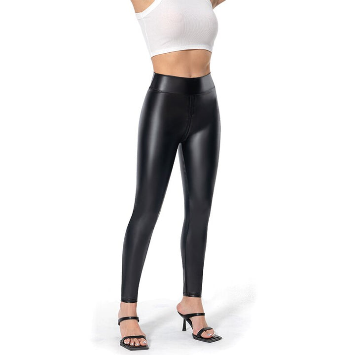 Black matte leather trousers for women styled with black heeled sandals and white crop top